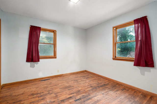 225 S Main St, Greenfield, MO 65661 - empty room featuring wood finished floors and plenty of natural light