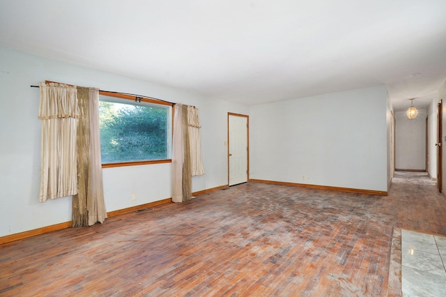 225 S Main St, Greenfield, MO 65661 - empty room with wood finished floors and baseboards