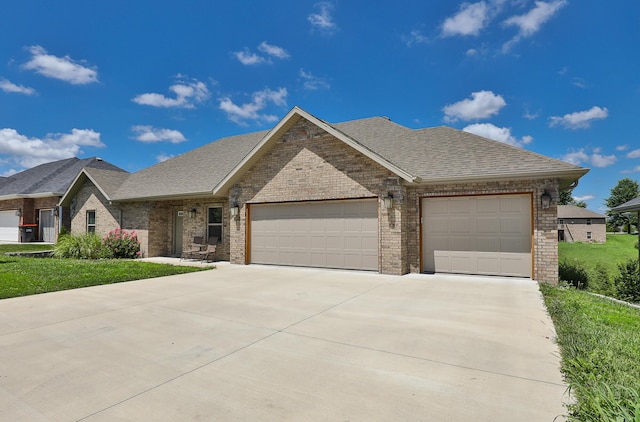 1929 N Brookhollow Dr, Nixa, MO 65714 - view of front of property featuring a garage, concrete driveway, brick siding, and roof with shingles
