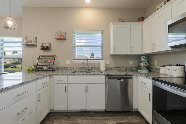 1929 N Brookhollow Dr, Nixa, MO 65714 - kitchen with appliances with stainless steel finishes, healthy amount of natural light, white cabinetry, dark wood finished floors, and recessed lighting