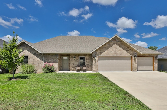 1929 N Brookhollow Dr, Nixa, MO 65714 - single story home featuring an attached garage, a front lawn, brick siding, and driveway