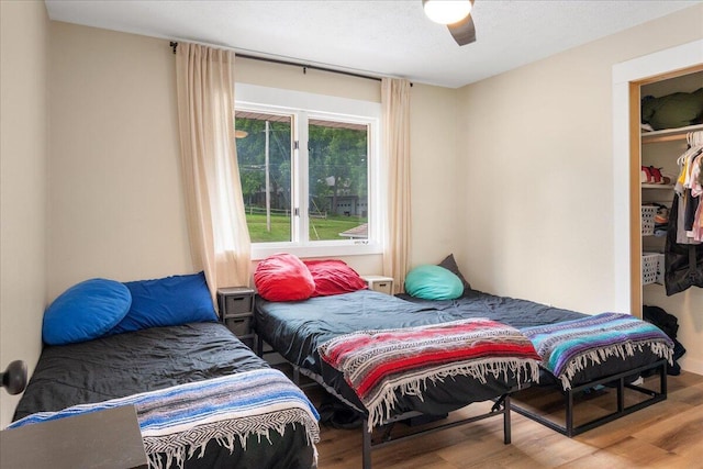 103 W Secluded Ln, Nixa, MO 65714 - bedroom featuring wood finished floors, a ceiling fan, and a closet