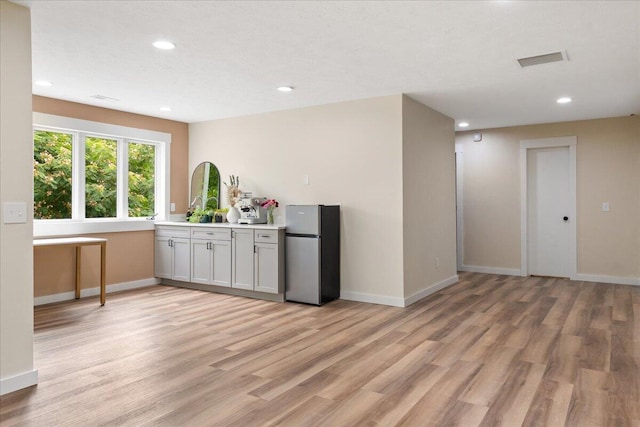 103 W Secluded Ln, Nixa, MO 65714 - kitchen with freestanding refrigerator, light wood-style floors, light countertops, and recessed lighting