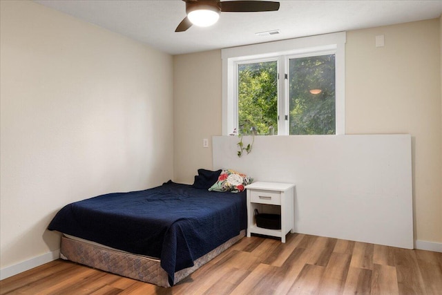 103 W Secluded Ln, Nixa, MO 65714 - bedroom with light wood finished floors and ceiling fan