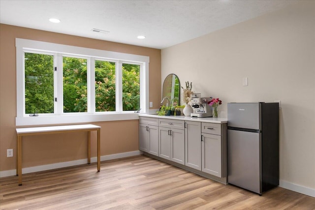103 W Secluded Ln, Nixa, MO 65714 - kitchen featuring freestanding refrigerator, gray cabinetry, light wood-style floors, light countertops, and recessed lighting