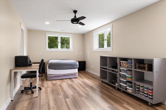 103 W Secluded Ln, Nixa, MO 65714 - bedroom featuring wood finished floors, multiple windows, recessed lighting, a desk, and ceiling fan