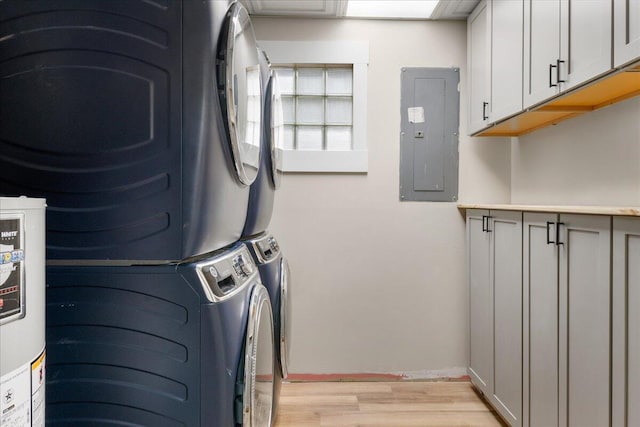 103 W Secluded Ln, Nixa, MO 65714 - washroom with electric panel, stacked washer / drying machine, light wood-style floors, cabinet space, and water heater