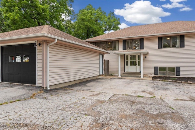 103 W Secluded Ln, Nixa, MO 65714 - view of front of property with a garage and a shingled roof
