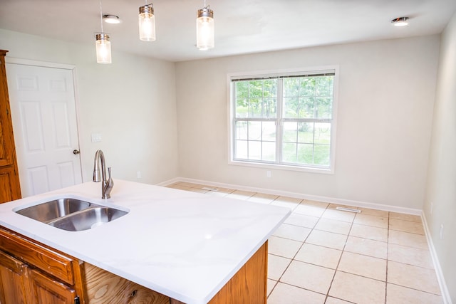 1719 N Pine St, Marshfield, MO 65706 - kitchen featuring light countertops, light tile patterned flooring, and brown cabinets