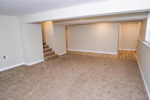 1719 N Pine St, Marshfield, MO 65706 - finished basement featuring carpet, stairs, and a textured ceiling