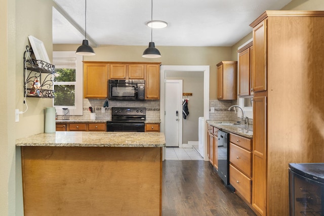 526 S Mccanse St, Mount Vernon, MO 65712 - kitchen featuring black appliances, decorative backsplash, wood finished floors, light stone countertops, and a peninsula
