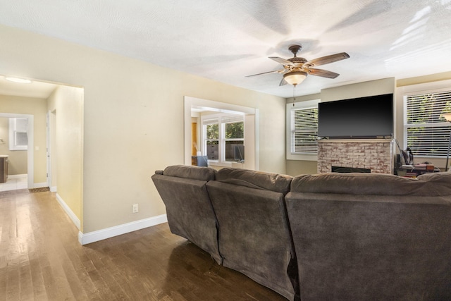 526 S Mccanse St, Mount Vernon, MO 65712 - living room with wood finished floors, ceiling fan, and a fireplace