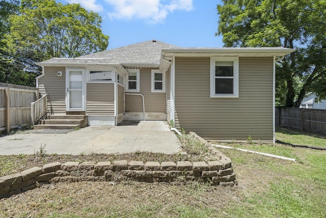 526 S Mccanse St, Mount Vernon, MO 65712 - rear view of house with entry steps, a fenced backyard, a patio, and a shingled roof
