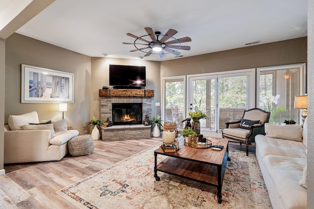 348 Sunset Cv Unit 413, Branson, MO 65616 - living area with a ceiling fan, wood finished floors, and a fireplace