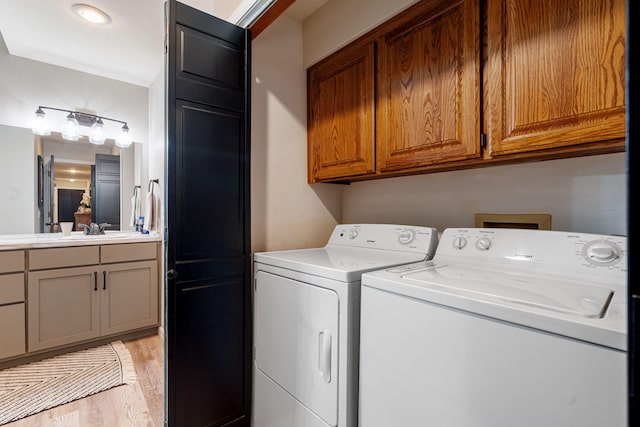 348 Sunset Cv Unit 413, Branson, MO 65616 - washroom featuring cabinet space, washing machine and dryer, and light wood-type flooring