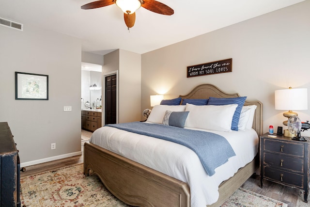 348 Sunset Cv Unit 413, Branson, MO 65616 - bedroom with wood finished floors, connected bathroom, and a ceiling fan