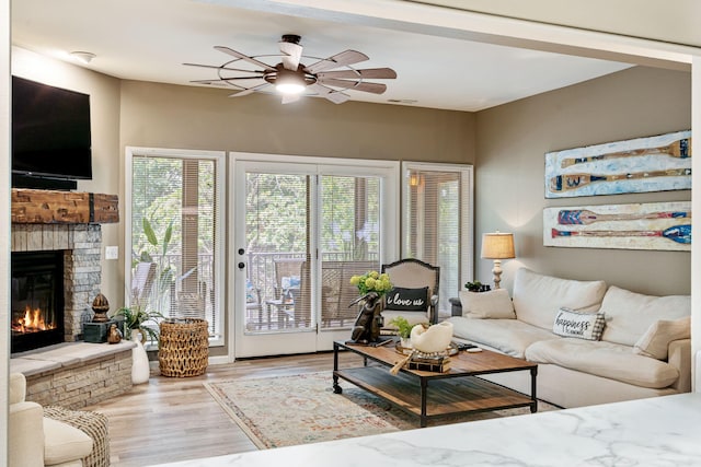 348 Sunset Cv Unit 413, Branson, MO 65616 - living room featuring a ceiling fan, wood finished floors, and a fireplace