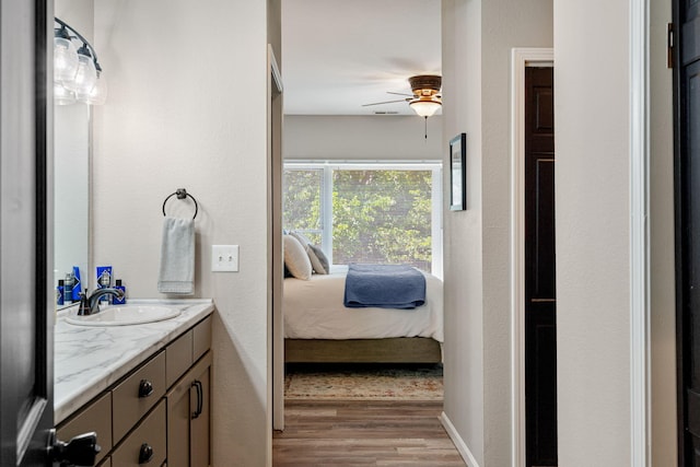 348 Sunset Cv Unit 413, Branson, MO 65616 - bathroom featuring vanity, wood finished floors, ceiling fan, and ensuite bathroom