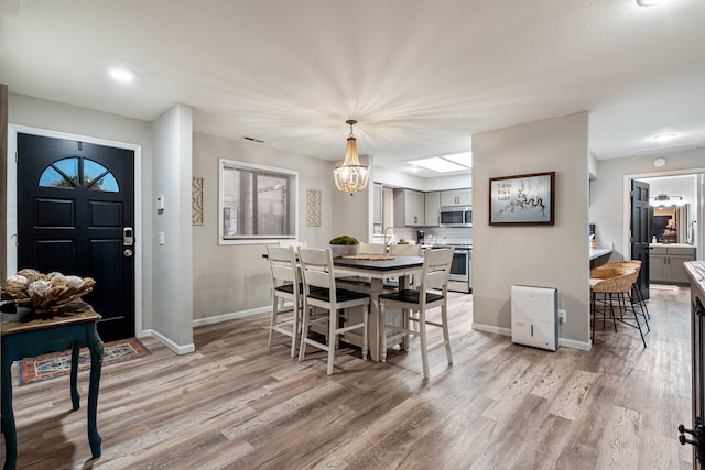 348 Sunset Cv Unit 413, Branson, MO 65616 - dining space featuring light wood-type flooring, a chandelier, and plenty of natural light