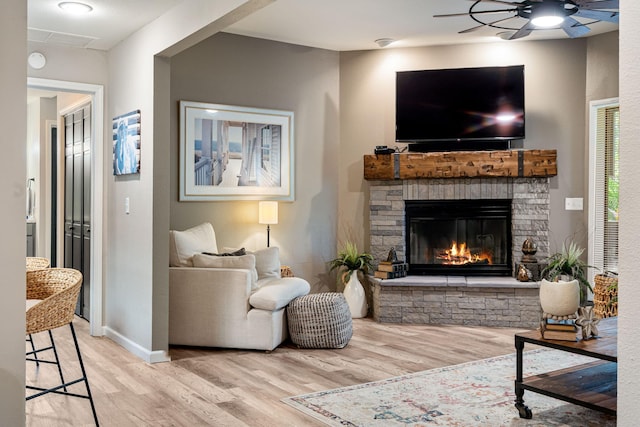 348 Sunset Cv Unit 413, Branson, MO 65616 - living area featuring wood finished floors, a fireplace, and ceiling fan