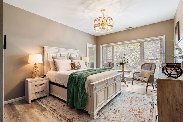 348 Sunset Cv Unit 413, Branson, MO 65616 - bedroom featuring light wood finished floors and a chandelier