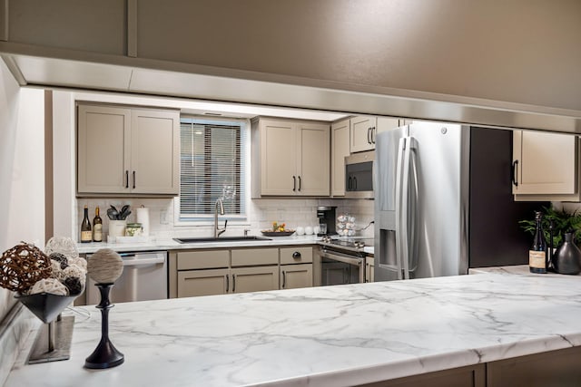 348 Sunset Cv Unit 413, Branson, MO 65616 - kitchen with stainless steel appliances, tasteful backsplash, light stone countertops, and gray cabinets