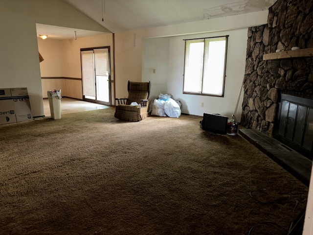 1334 E Nora St, Springfield, MO 65803 - living area with carpet floors, a stone fireplace, and vaulted ceiling