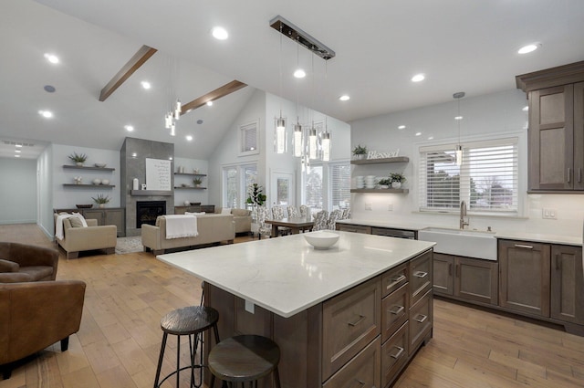 4113 S Farm Rd Unit 223, Rogersville, MO 65742 - kitchen featuring a breakfast bar, open floor plan, open shelves, light wood-style floors, and a center island
