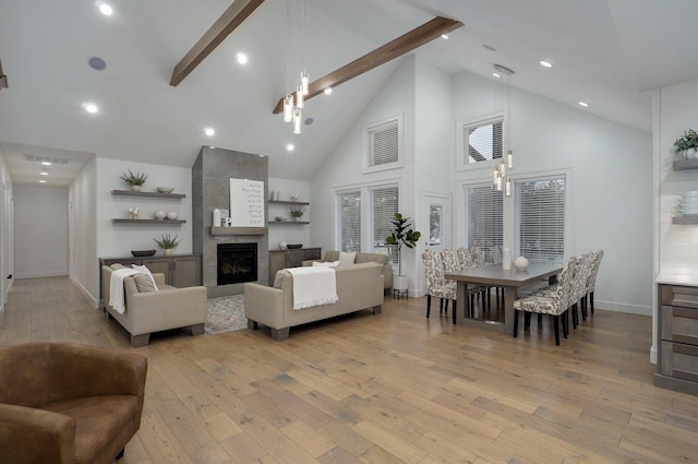 4113 S Farm Rd Unit 223, Rogersville, MO 65742 - living room featuring beamed ceiling, light wood-type flooring, high vaulted ceiling, and a tile fireplace