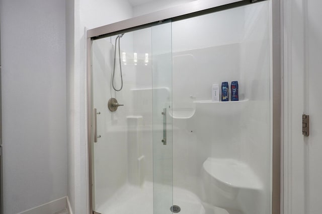 4113 S Farm Rd Unit 223, Rogersville, MO 65742 - bathroom featuring a stall shower and baseboards
