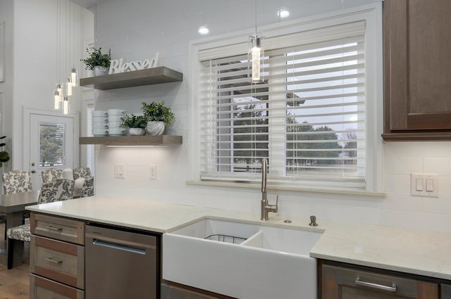 4113 S Farm Rd Unit 223, Rogersville, MO 65742 - kitchen featuring stainless steel dishwasher, open shelves, decorative backsplash, hanging light fixtures, and light stone counters