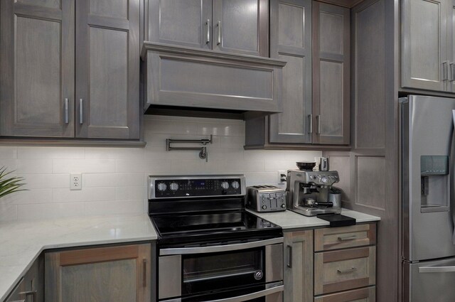 4113 S Farm Rd Unit 223, Rogersville, MO 65742 - kitchen featuring stainless steel appliances, backsplash, ventilation hood, and light stone countertops