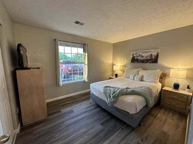 17 Fall Creek Trl Unit 4, Branson, MO 65616 - bedroom with dark wood finished floors and a textured ceiling