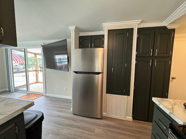 110 Blue-Bird Ln, Branson, MO 65616 - kitchen featuring freestanding refrigerator, light wood finished floors, and light stone countertops