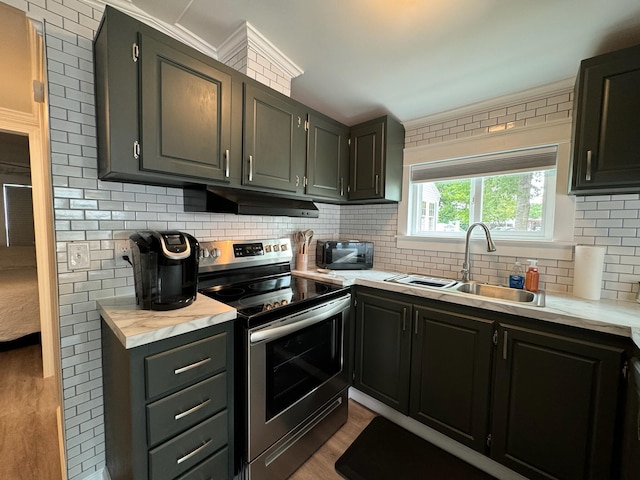 110 Blue-Bird Ln, Branson, MO 65616 - kitchen featuring stainless steel range with electric stovetop, under cabinet range hood, decorative backsplash, light countertops, and wood finished floors