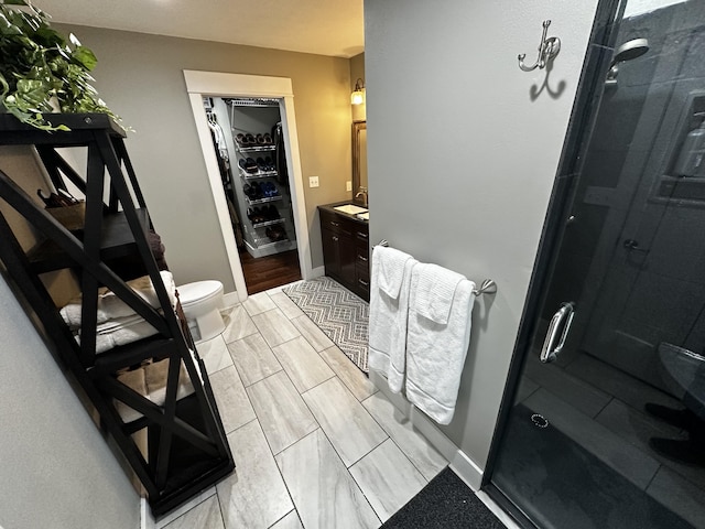 1179 N Pine St, Marshfield, MO 65706 - bathroom featuring vanity, a shower stall, and a walk in closet