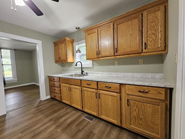 609 S College St, Neosho, MO 64850 - kitchen featuring a ceiling fan, brown cabinets, dark wood-type flooring, and decorative light fixtures