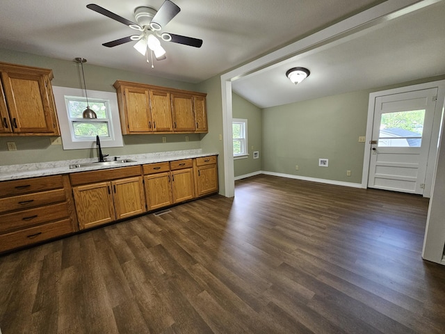 609 S College St, Neosho, MO 64850 - kitchen with brown cabinets, light countertops, dark wood finished floors, hanging light fixtures, and vaulted ceiling