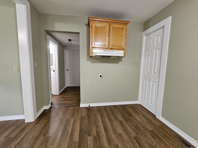 609 S College St, Neosho, MO 64850 - laundry area featuring cabinet space, electric dryer hookup, and dark wood-type flooring