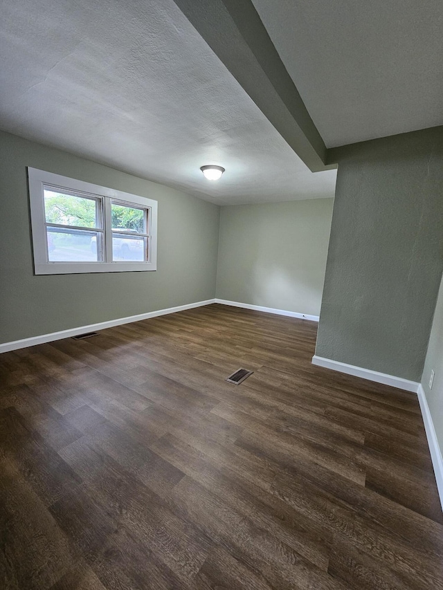 609 S College St, Neosho, MO 64850 - spare room featuring dark wood-style floors and a textured ceiling