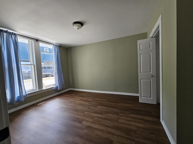609 S College St, Neosho, MO 64850 - empty room featuring dark wood finished floors
