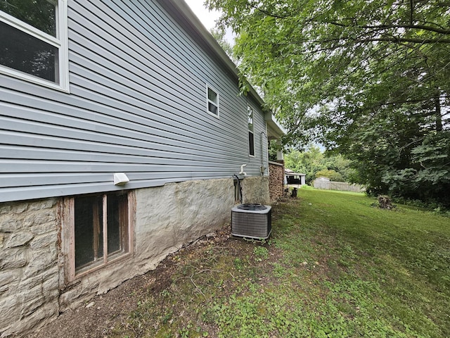 609 S College St, Neosho, MO 64850 - view of side of property featuring a central air condition unit and a lawn