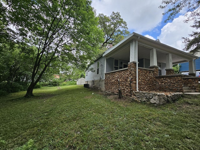 609 S College St, Neosho, MO 64850 - view of side of property with a yard, stone siding, and a porch