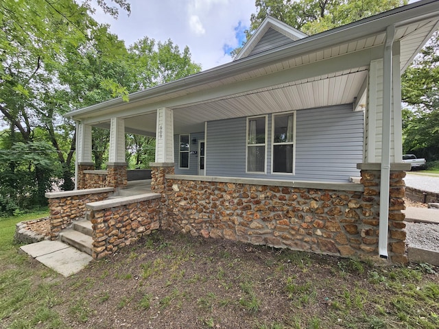 609 S College St, Neosho, MO 64850 - view of front of home with covered porch and stone siding
