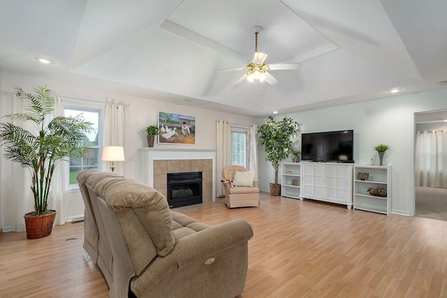 1060 Berkley, Marshfield, MO 65706 - living room featuring plenty of natural light, a tiled fireplace, ceiling fan, light wood-style floors, and recessed lighting