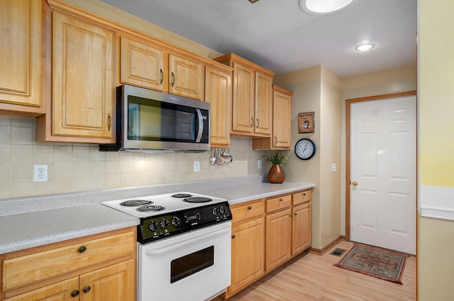 1060 Berkley, Marshfield, MO 65706 - kitchen featuring stainless steel microwave, electric stove, light countertops, and light wood finished floors