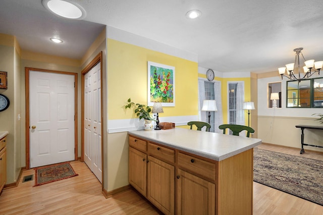 1060 Berkley, Marshfield, MO 65706 - kitchen with a peninsula, light countertops, light wood-type flooring, a chandelier, and recessed lighting
