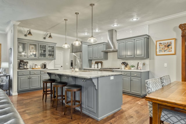1251 S Rosemoor Dr, Nixa, MO 65714 - kitchen with gray cabinets, wall chimney exhaust hood, stainless steel appliances, ornamental molding, and backsplash