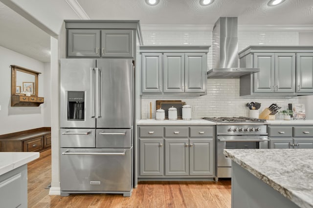 1251 S Rosemoor Dr, Nixa, MO 65714 - kitchen featuring premium appliances, gray cabinets, wall chimney exhaust hood, light wood-type flooring, and light countertops