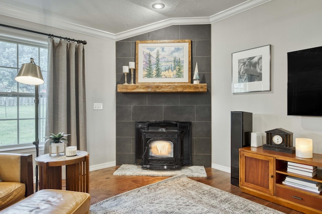 1251 S Rosemoor Dr, Nixa, MO 65714 - living room featuring wood finished floors, ornamental molding, healthy amount of natural light, a wood stove, and lofted ceiling